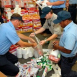 Technicians helping to pack care packages for those in need.