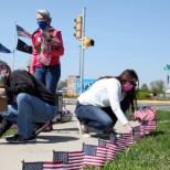 WPS employees planting American flags to honor fallen service members for Memorial Day.